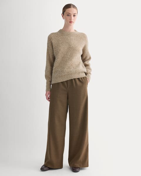 A pair of dark brown wide-leg trousers against a light background.
