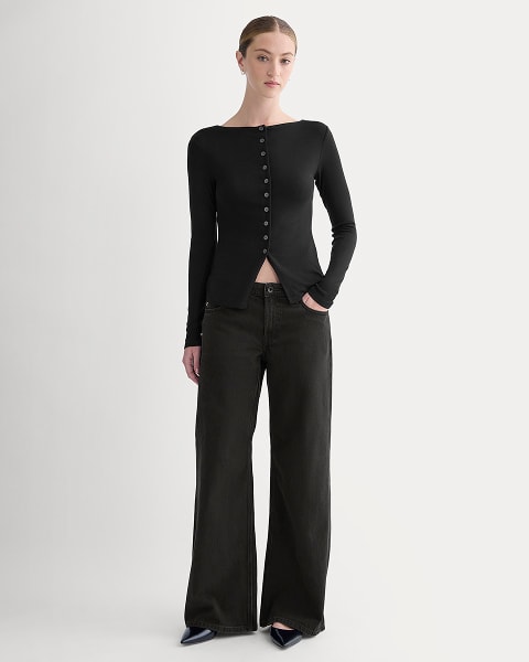 A rust orange puffer jacket laid flat against a light background.