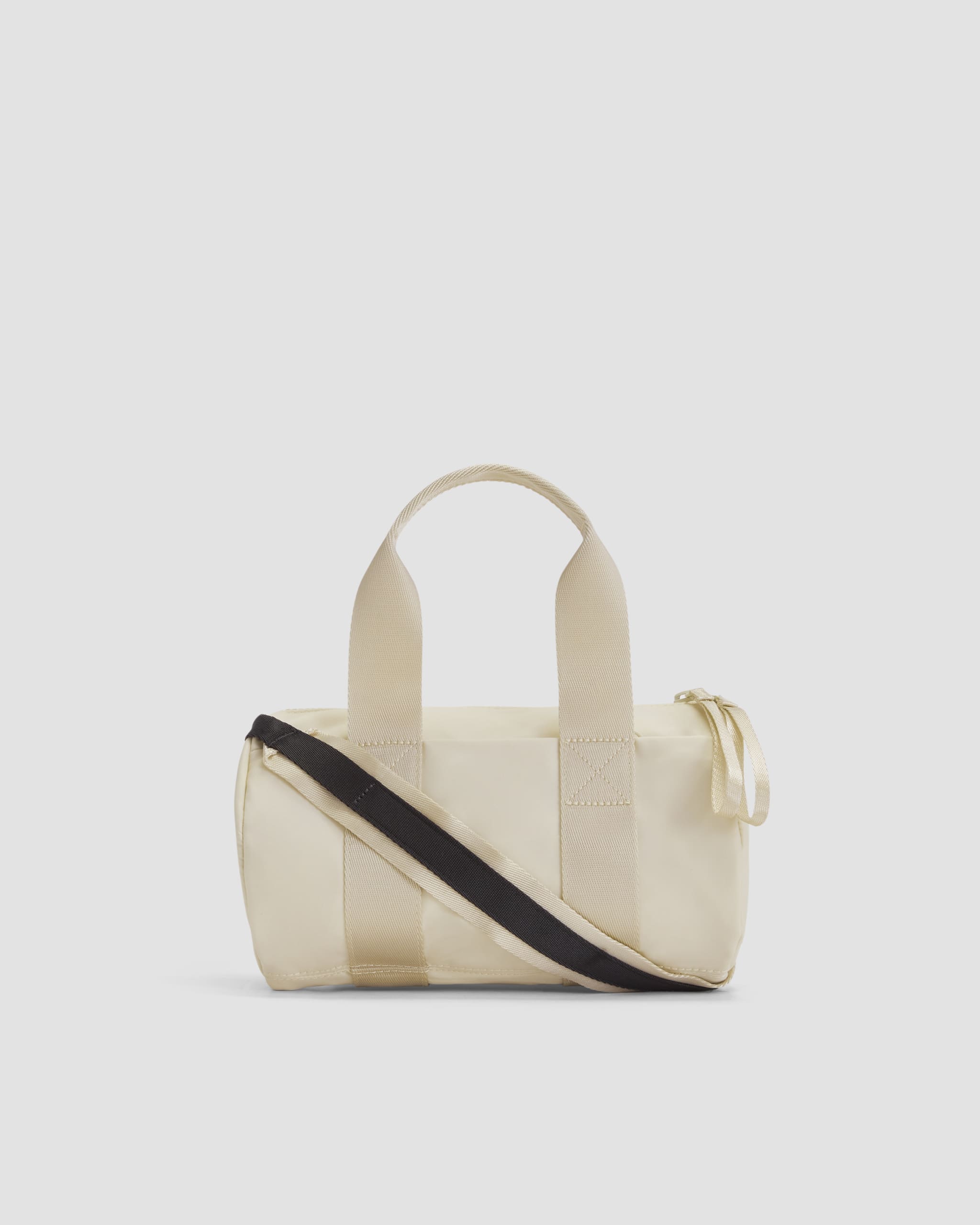 A tan duffle bag with a black strap